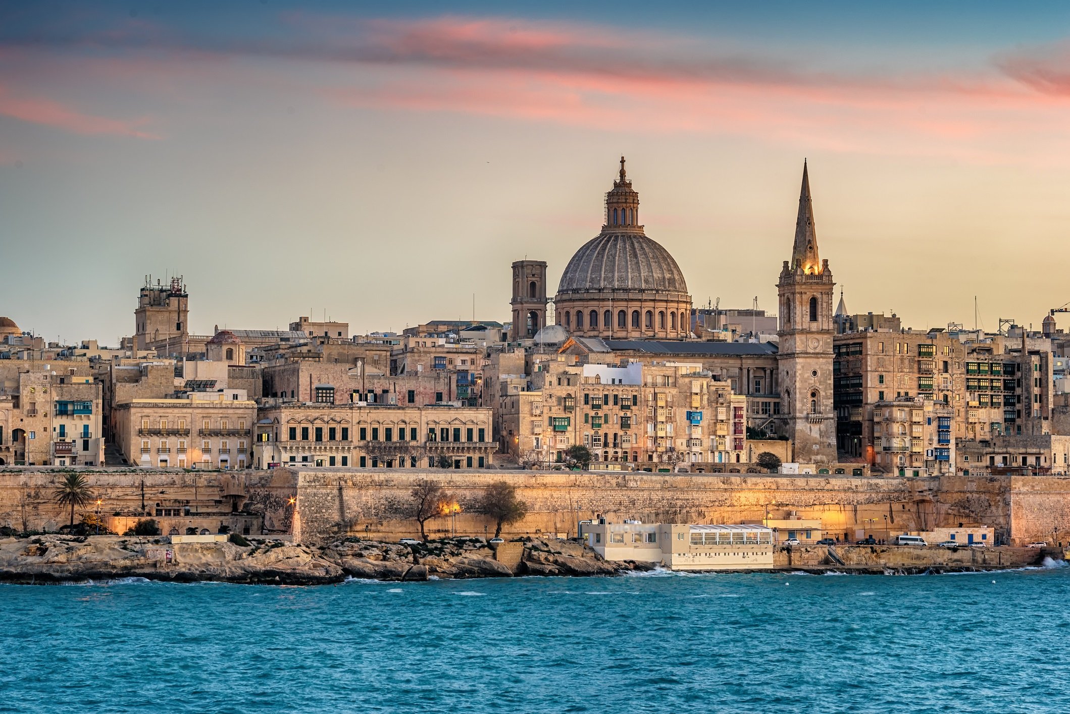 Valletta, Malta: skyline from Marsans Harbour at sunset. The cathedral